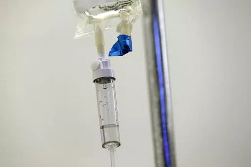 In this May 25, 2017 file photo, chemotherapy drugs are administered to a patient at a hospital in Chapel Hill, N.C. Scaling back treatment in some cancers — ovarian, esophageal and Hodgkin lymphoma — can make life easier for patients without compromising outcomes, doctors reported at the American Society of Clinical Oncology annual meeting in early June 2024. (AP Photo/Gerry Broome, File)