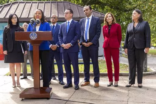 Kristen Clarke, at podium, Assistant Attorney General for the Justice Department's Civil Rights Division, is joined with, from left, New Jersey First Assistant Attorney General Lyndsay Ruotolo, Pennsylvania state Sen. Vincent Hughes, Pennsylvania Attorney General Josh Shapiro, Rohit Chopra, CFPB Director, Delaware Attorney General Kathy Jennings and Jacqueline C. Romero, United States Attorney for the Eastern District of Pennsylvania during a press conference at Malcolm X Park, Wednesday morning