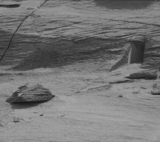 This image made available by NASA was taken by the Mast Camera onboard NASA's Mars rover Curiosity on Sol 3466, May 7, 2022.  On Friday, May 20, 2022,  The Associated Press reported on stories circulating online incorrectly claiming NASA’s Mars rover has captured images of a doorway cut into a mountainside of the red planet, suggesting the presence of extraterrestrial life.    (NASA/JPL-Caltech/MSSS via AP)