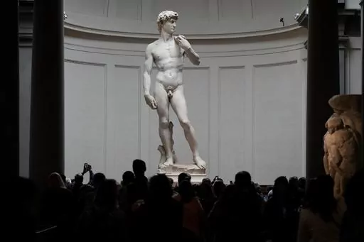 Visitors stand in front of Michelangelo's "David statue" in the Accademia Gallery in Florence, Italy, Tuesday, March 28, 2023. The Florence museum and the city's mayor are inviting parents and students from a Florida charter school to visit and see Michelangelo's sculpture of David. The invitation comes after the school principal was forced to resign following parental complaints that an image of the nude Renaissance masterpiece was shown to a sixth-grade art class. (AP Photo/Alessandra Tarantin