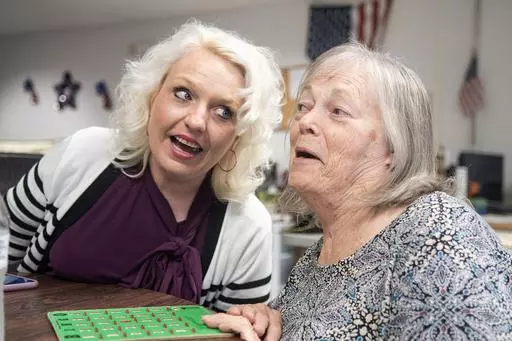 VNA Caring Center Director Angela Loeper, left, sings an oldies tune with client Marilyn Vargo of Milton, Pa., during at the center in Shamokin, Pa., on Thursday, May 9, 2024. The facility is the only adult day services program for cognitively impaired seniors in the Susquehanna Valley. (Robert Inglis/CNHI News via AP)