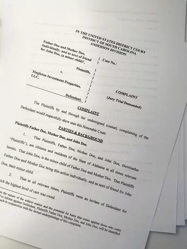 A lawsuit is seen on Thursday, July 27, 2023, in Atlanta. The parents of a teenager with special needs say he was repeatedly sexually assaulted and raped by an employee at the small private boarding school in South Carolina. They have sued the school's parent company, which has denied the allegations. (AP Photo/Brynn Anderson)