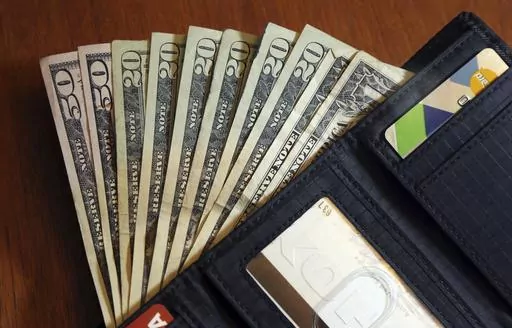 In this June 15, 2018, file photo, cash is fanned out from a wallet in North Andover, Mass. People often assume estate planning starts when you’re rich, have a family or are elderly, but it can begin as early as your late teens. Parents can start the conversation by explaining their own estate plan and why it’s important to have one. This helps younger children understand they’ll be cared for no matter what happens. (AP Photo/Elise Amendola, File)