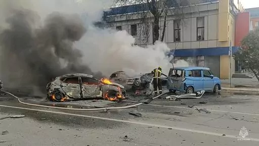 In this photo taken from video released by Russia Emergency Situations Ministry telegram channel on Saturday, Dec. 30, 2023, firefighters extinguish burning cars after shelling in Belgorod, Russia. Russian air defenses downed dozens of Ukrainian drones aimed at occupied Crimea and southern Russia, officials said Friday Jan. 5, 2024. (Russia Emergency Situations Ministry telegram channel via AP, File)