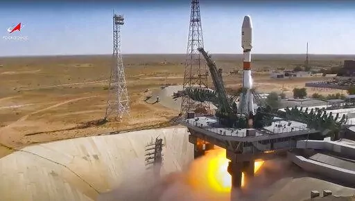 In this handout photo taken from video released by Roscosmos on Tuesday, Aug. 9, 2022, a Russian Soyuz rocket lifts off to carry Iranian Khayyam satellite into orbit at the Russian leased Baikonur cosmodrome near Baikonur, Kazakhstan. A Russian rocket has successfully launched an Iranian satellite into orbit. The Soyuz rocket lifted off as scheduled at 8:52 a.m. Moscow time (0552 GMT) Tuesday from the Russia-leased Baikonur launch facility in Kazakhstan. (Roscosmos via AP)