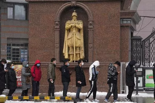 Workers from the restaurant industry line up for their covid tests in Beijing, China, Saturday, Jan. 22, 2022. Chinese authorities have called on the public to stay where they are during the Lunar New Year instead of traveling to their hometowns for the year's most important family holiday. (AP Photo/Ng Han Guan)
