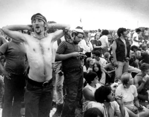 Music fans relax during a break in the entertainment at the Woodstock Music and Arts Fair, Aug. 16, 1969, in Bethel, N.Y. An estimated 450,000 people attended the Woodstock festival in August 1969, and most of that crowd was composed of teenagers or young adults now in the twilight of their lives. That ticking clock is why the Museum at Bethel Woods, based at the site of the festival, is immersed in a five-year project traveling around the United States recording the oral histories of people wer