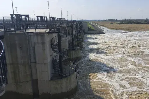 This photo provided by the state company Polish Waters shows the Oder River flood waters channelled into and contained by the newly-built Lower Raciborz Reservoir that has spared the cities of Opole and Wroclaw from flooding, in Raciborz, southwestern Poland, Sept. 23, 2024. (Polish Waters via AP)