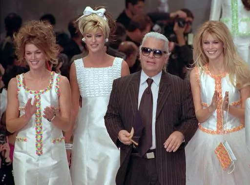 German designer Karl Lagerfeld joins models, from left, American Cindy Crawford, Canadian Linda Evangelista and Claudia Schiffer of Germany after the presentation of his 1996 spring-summer ready-to-wear fashion collection for Chanel in Paris on Oct. 19, 1995. Lagerfeld died in 2019 after dominating the fashion universe into his 80s. Come May 1, his legacy will be on display at the Met Gala and the starry fundraising party's companion exhibition at the Metropolitan Museum of Art's Costume Institu