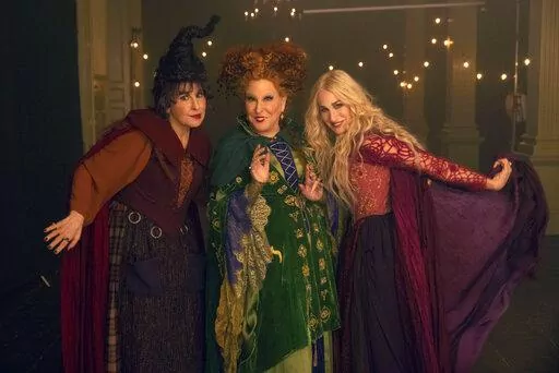 This image released by Disney shows, from left, Kathy Najimy as Mary Sanderson, Bette Midler as Winifred Sanderson, and Sarah Jessica Parker as Sarah Sanderson in "Hocus Pocus 2." (Matt Kennedy/Disney via AP)