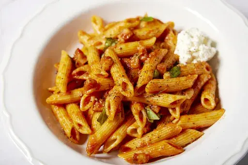 This image released by Milk Street shows a recipe for pasta with spicy tomato and pancetta sauce. (Milk Street via AP)