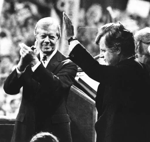 U.S. President Jimmy Carter, left, applauds as Sen. Edward Kennedy waves to cheering delegates at the Democratic National Convention in New York's Madison Square Garden, Aug. 14, 1980. As Carter receives home hospice care at the age of 98, misconceptions about his life are coming into focus. Most are rooted in some truth but need more context. (AP Photo, File)