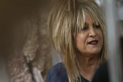 Elizabeth Emanuel, who designed Diana, Princess of Wales wedding dress, looks on at her studio during an interview with the Associated Press in Maida Vale, London, Monday, Aug. 22, 2022. (AP Photo/Alastair Grant)