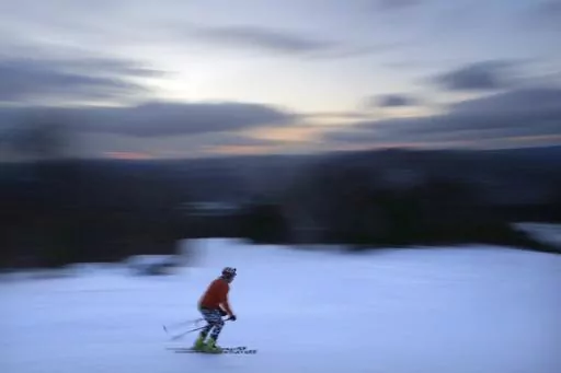 A skier descends Black Mountain of Maine, Feb. 11, 2023, in Rumford, Maine. A new study says U.S. ski areas lost about $5 billion from 2000 to 2019 as a result of human-caused climate change. (AP Photo/Robert F. Bukaty, File)