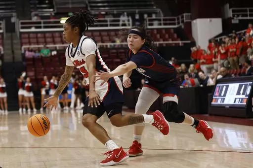 Mississippi guard Angel Baker (15) drives to the basket against Gonzaga guard Kaylynne Truong, right, in the first half of a first-round college basketball game in the women's NCAA Tournament in Stanford, Calif., Friday, March 17, 2023. (AP Photo/Josie Lepe)