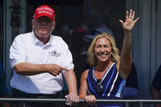 Rep. Marjorie Taylor Greene, R-Ga., waves while former President Donald Trump points to her while they look over the 16th tee during the second round of the Bedminster Invitational LIV Golf tournament in Bedminster, N.J., July 30, 2022. Republicans ranging from Senate Minority Leader Mitch McConnell to Marjorie Taylor Greene defended Trump against an unprecedented FBI search. (AP Photo/Seth Wenig, File)