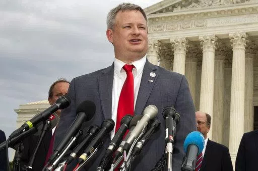 South Dakota Attorney General Jason Ravnsborg, joined by a bipartisan group of state attorneys general, speaks to reporters in front of the U.S. Supreme Court in Washington on Sept. 9, 2019. The South Dakota House is set to decide Tuesday, April 12, 2022, whether Ravnsborg should be impeached for his conduct before and after he struck and killed a pedestrian on the shoulder of a highway. (AP Photo/Manuel Balce Ceneta, File)
