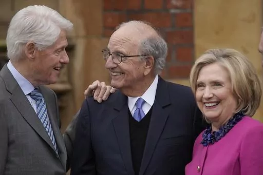 Former US President Bill Clinton, from left, former U.S. Sen. George Mitchell, and former US Secretary of State Hillary Clinton chat on the first day of a three-day international conference at Queen's University Belfast to mark the 25th anniversary of the Good Friday Agreement, in Belfast, Northern Ireland, Monday, April 17, 2023. Former U.S. President Bill Clinton and past leaders of the U.K. and Ireland are gathering in Belfast on Monday, 25 years after their charm, clout and determination hel
