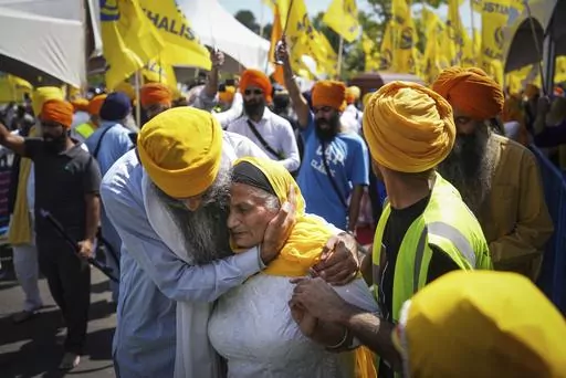 A woman is consoled as people mourn Sikh community leader and temple president Hardeep Singh Nijjar during Antim Darshan, the first part of day-long funeral services for him, in Surrey, British Columbia, Sunday, June 25, 2023. Nijjar was gunned down in his vehicle while leaving the Guru Nanak Sikh Gurdwara Sahib parking lot. The September 2023 accusation by Canadian Prime Minister Justin Trudeau that India may have been behind the assassination of Nijjar, a Sikh separatist leader, has raised sev