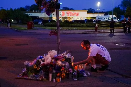 A person pays his respects at a makeshift memorial outside the scene of a shooting at a supermarket in Buffalo, N.Y., Sunday, May 15, 2022. (AP Photo/Matt Rourke, File)