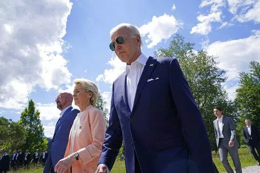 President Joe Biden, right, walks with European Commission President Ursula von der Leyen, center, and European Council President Charles Michel, left, as they head to a family photo with the G7 leaders at the G7 Summit in Elmau, Germany, Sunday, June 26, 2022. (AP Photo/Susan Walsh, Pool)