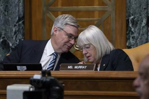 Senate Budget Committee Chairman Sheldon Whitehouse, D-R.I., confers with Sen. Patty Murray, D-Wash., right, during a hearing on the Republican proposal to address the debt limit which passed along party lines in the House last week, at the Capitol in Washington, Thursday, May 4, 2023. Senate Democrats are looking to pressure Republicans into resolving the impasse on the debt ceiling. (AP Photo/J. Scott Applewhite)