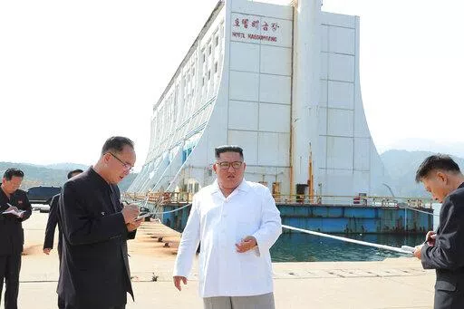 In this undated photo provided on Oct. 23, 2019, by the North Korean government, North Korean leader Kim Jong Un, center, visits the Diamond Mountain resort in Kumgang, North Korea. South Korean officials confirmed Friday, April 8, 2022, that North Korea is dismantling a South Korean-owned hotel at its Diamond Mountain resort and called for the North to stop its “unilateral” destruction of one of the few remaining symbols of inter-Korean engagement.  Independent journalists were not given ac