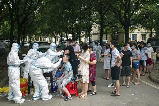 Residents line up to be tested for COVID-19 in Wuhan, central China's Hubei province on Aug. 3, 2021. Two new studies provide more evidence that the coronavirus pandemic originated in a Wuhan, China market where live animals were sold – further bolstering the theory that the virus emerged in the wild rather than escaping from a Chinese lab. The research was published online Tuesday, July 26, 2022, by the journal Science. (Chinatopix via AP, File)