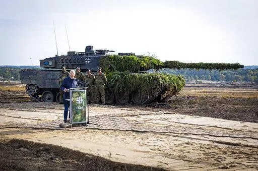 German Chancellor Olaf Scholz speaks to soldiers in front of a Leopard 2 main battle tank after the Army's training and instruction exercise in Ostenholz, Germany, Monday, oct. 17, 2022. Germany has become one of Ukraine's leading weapons suppliers in the 11 months since Russia's invasion. The debate among allies about the merits of sending battle tanks to Ukraine has focused the spotlight relentlessly on Germany, whose Leopard 2 tank is used by many other countries and has long been sought by K