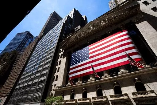 An American flag is displayed on the facade of the New York Stock Exchange on June 29, 2022, in New York. Investors had few places to hide in 2022: Stocks and bonds both nose-dived and crypto tanked. Pocketbook issues were front and center for consumers as prices for food, energy and rent jumped. (AP Photo/Julia Nikhinson, File)