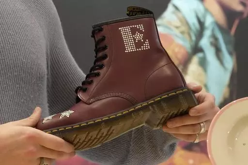 A Dr Martens boot inspired by Elton John's famous Pinball Wizard outfit is shown at a promotional event in London, March 20, 2023. Dr. Martens shares plunged more than 30% Tuesday, April 16, 2024 after the trendy British brand forecast that wholesale revenue in the U.S., its largest market, would decline by double-digits compared to that seen a year ago. (AP Photo/Kin Cheung, File)