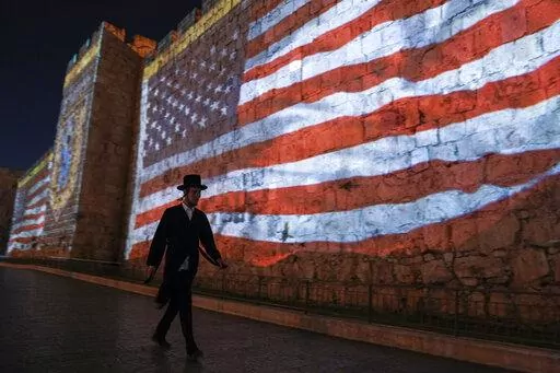 An image of the U.S. flag is projected on the walls of Jerusalem's Old City in honor of President Joe Biden's visit to Jerusalem, Wednesday, July 13, 2022. Several U.S. Jewish leaders are sounding alarms about what they see as a threat to Israel’s democracy posed by its new government, the Likud party led by Benjamin Netanyahu who took office in December 2022, fearing it will erode the independence of its judiciary and legal protections for minority groups. (AP Photo/Mahmoud Illean, File)