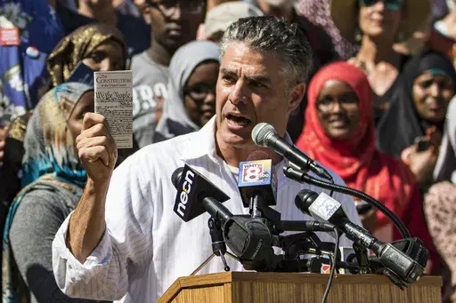 Portland Mayor Ethan Strimling holds up a copy of the U.S. Constitution at a rally at City Hall to protest comments by Republican presidential candidate Donald Trump, Friday, Aug. 5, 2016 in Portland, Maine. Strimling, who says his landlord tried to evict him because he formed a tenants union, can stay in the apartment after a jury concluded his landlord retaliated against him, Thursday, June 27, 2024. (Ben McCanna/Portland Press Herald via AP, File)