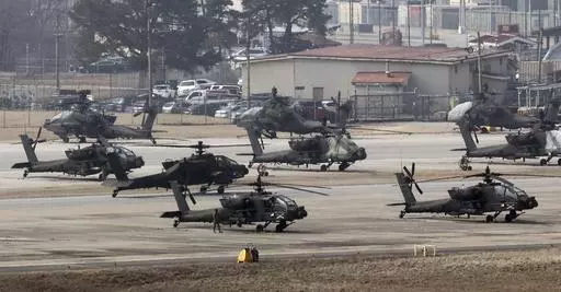 U.S. Army Apache helicopters take off at Camp Humphreys in Pyeongtaek, South Korea, Monday, March 4, 2024. North Korea called the ongoing South Korean-U.S. military drills a plot to invade the country, as it threatened Tuesday to take unspecified "responsible" military steps in response. (Kwon June-woo/Yonhap via AP)