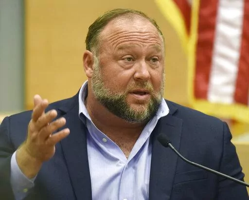 Conspiracy theorist Alex Jones takes the witness stand to testify at the Sandy Hook defamation damages trial at Connecticut Superior Court in Waterbury, Conn. Thursday, Sept. 22, 2022.  On Friday, Oct. 21, Jones has asked a Connecticut judge to throw out a nearly $1 billion verdict against him and order a new trial in a lawsuit by Sandy Hook families over Jones' lies that the 2012 Newtown school shooting was a hoax.(Tyler Sizemore/Hearst Connecticut Media via AP, Pool, File)