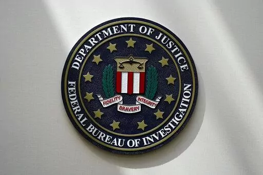 The FBI seal is pictured in Omaha, Neb., Aug. 10, 2022. The FBI is searching for a Florida woman who was supposed to stand trial Monday, March 6, 2023, on charges stemming from the Jan. 6, 2021, Capitol attack as well as another riot defendant who has gone missing. An FBI agent said Monday that a federal judge in Washington issued bench warrants for the arrest of Olivia Pollock and Joseph Hutchinson III last week after the court was notified that they had tampered with or removed the ankle monit
