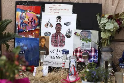 In this July 3, 2020, file photo, a makeshift memorial stands at a site across the street from where Elijah McClain was stopped by police officers while walking home in Aurora, Colo. A trial for two of the officers charged for Elijah McClain's death is set to begin Friday, Sept. 15, 2023 with jury selection. (AP Photo/David Zalubowski, File)