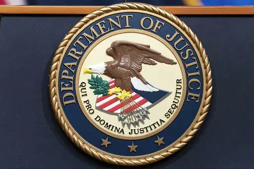 The Department of Justice seals is seen during a news conference at the DOJ office in Washington, May 16, 2023. (AP Photo/Jose Luis Magana, File)