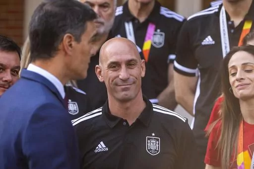 President of Spain's soccer federation Luis Rubiales, stands with Spain's Women's World Cup soccer team after being received by Spain's Prime Minister Pedro Sanchez, left, at La Moncloa Palace in Madrid, Spain, Tuesday, Aug. 22, 2023. The kiss by Luis Rubiales has unleashed a storm of fury over gender equality that almost marred the unprecedented victory but now looks set to go down as a milestone in both Spanish soccer history but also in women's rights.(AP Photo/Manu Fernandez, file)