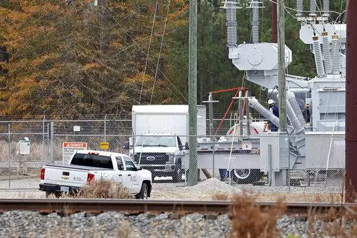Workers work on equipment at the West End Substation, at 6910 NC Hwy 211 in West End, N.C., Monday, Dec. 5, 2022, where a serious attack on critical infrastructure has caused a power outage to many around Southern Pines, N.C. The North Carolina lawmaker who represents a county where gunfire at electrical substations cut power to thousands in December is pushing legislation to increase power grid security when the legislative session begins in earnest next week. (AP Photo/Karl B DeBlaker, File)