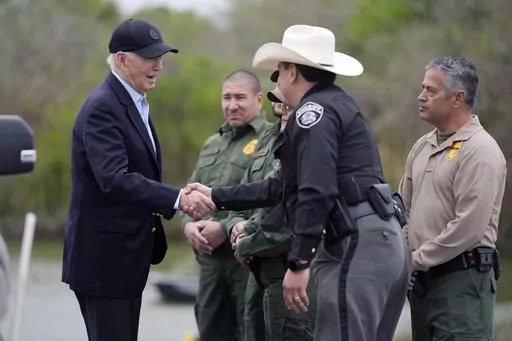 President Joe Biden talks with the U.S. Border Patrol and local officials as he looks over the southern border, Feb. 29, 2024, in Brownsville, Texas, along the Rio Grande. Democrats are trying to outflank Republicans and convince voters they can address problems at the U.S. border with Mexico as immigration likely becomes a major issue in elections that will decide control of Congress. (AP Photo/Evan Vucci, File)