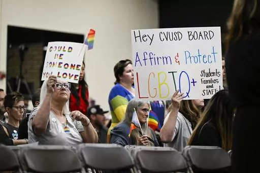 Parents, students, and staff of Chino Valley Unified School District hold up signs in favor of protecting LGBTQ+ policies at Don Antonio Lugo High School, on Thursday, June 15, 2023. California's attorney general has sued a Southern California school district over its new policy that requires schools to notify parents if their children change their gender identification or pronouns. Attorney General Rob Bonta announced the suit Monday, Aug. 28, against Chino Valley Unified School District. (Phot