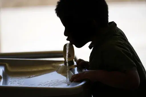 A student drinks from a water fountain at an elementary school in California on Sept. 20, 2023. (AP Photo/Marcio Jose Sanchez, File)