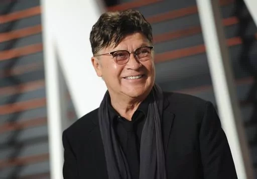 Musician Robbie Robertson arrives at the Vanity Fair Oscar Party on Sunday, Feb. 22, 2015, in Beverly Hills, Calif. Robertson, the lead guitarist and songwriter for The Band, whose classics include “The Weight,” “Up on Cripple Creek” and “The Night They Drove Old Dixie Down,” has died at 80, according to a statement from his manager. (Photo by Evan Agostini/Invision/AP, File)