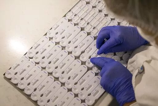 A employees works at NG Biotech, a start-up that makes an array of medical tests, including kits for use at home and by medical professionals to detect COVID-19 infections , in Guipry, western France, Friday, Jan. 7, 2022. With France breaking records in Europe for coronavirus infections, manufacturers are working flat-out to try to meet the huge demand for tests. (AP Photo/Jeremias Gonzalez)