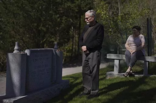 Co-presidents of New Light Congregation, Stephen Cohen and Barbara Caplan, visit a memorial in the New Light Cemetery on Wednesday, April 19, 2023, in Shaler Township, Pa., honoring the congregants they lost during the Pittsburgh synagogue massacre over four years ago. Jury selection is scheduled to begin on Monday, April 24, for the suspect accused of invading the Tree of Life synagogue building on that Sabbath morning and murdering 11 worshippers from three congregations. (AP Photo/Jessie Ward