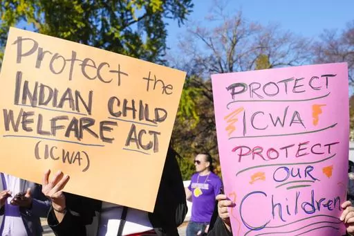 Demonstrators stand outside the U.S. Supreme Court in Washington, Nov. 9, 2022, as the court hears arguments over the Indian Child Welfare Act. On Thursday, June 15, 2023, the Supreme Court preserved the system that gives preference to Native American families in foster care and adoption proceedings of Native children, leaving in place the 1978 Indian Child Welfare Act that aims to prevent children from being separated from their families to be placed in non-Native homes. (AP Photo/Mariam Zuhaib