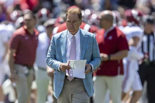 Alabama head coach Nick Saban paces as his team warms up before Alabama's A-Day NCAA college football scrimmage, Saturday, April 22, 2023, in Tuscaloosa, Ala. Saban says college football is not a business that operates like the NFL and warned that without more uniform rules on player compensation only the biggest spenders will compete for championships. (AP Photo/Vasha Hunt, File)
