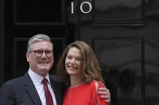 Britain's Labour Party Prime Minister Keir Starmer and his wife Victoria pose for the media on the doorstep of 10 Downing Street in London, Friday, July 5, 2024.After a few hours of sleep to shake off a night of celebration and an audience with the king, Keir Starmer will step through the front door of 10 Downing St. for the first time as prime minister on Friday. (AP Photo/Kin Cheung, File)