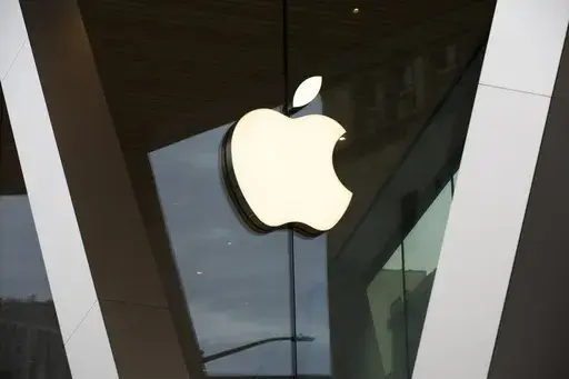 An Apple logo adorns the facade of the downtown Brooklyn Apple store on March 14, 2020, in New York. Apple Inc. plans to add several new features to Apple Pay and Apple Wallet later this year that will more deeply integrate financing, rewards, and buy now, pay later options into the iPhone when consumers shop on their phones. (AP Photo/Kathy Willens, File)
